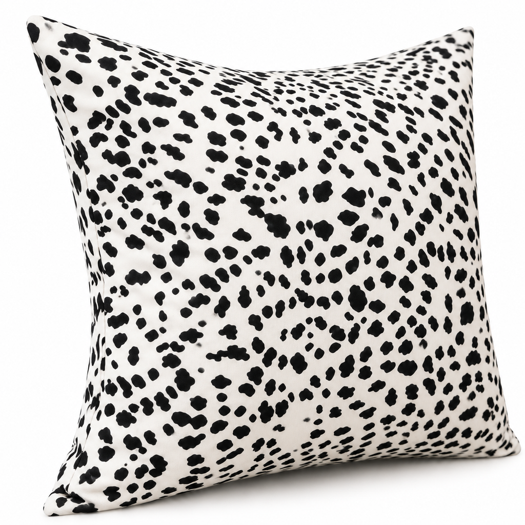 Angled view of black and white spotted cushion