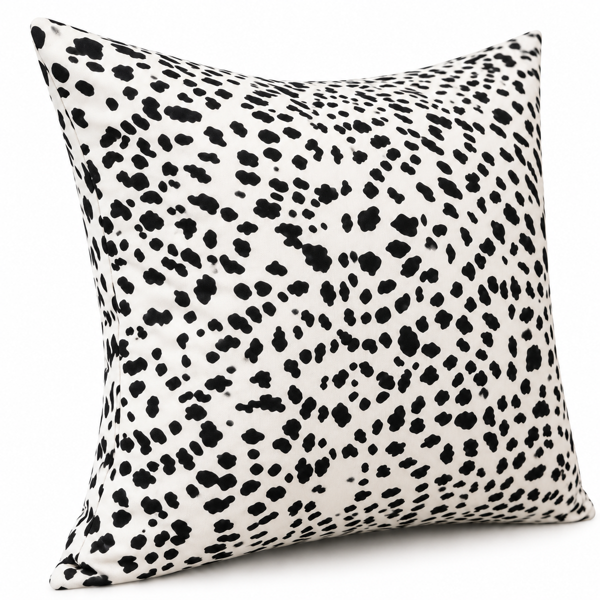 Angled view of black and white spotted cushion