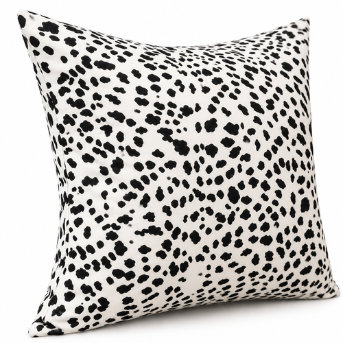 Angled view of black and white spotted cushion