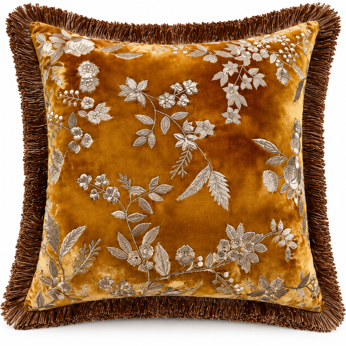 Front view of golden ochre cushion with silver-toned floral design and brown fringe