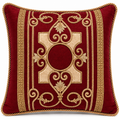 Front view of deep maroon cushion with gold scrollwork and cream accents