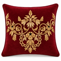 Front view of deep maroon cushion with ornate gold floral motif