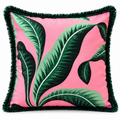 Front view of pink cushion with large green tropical leaves and fringe