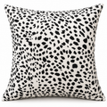 Front view of white cushion with irregular black spots