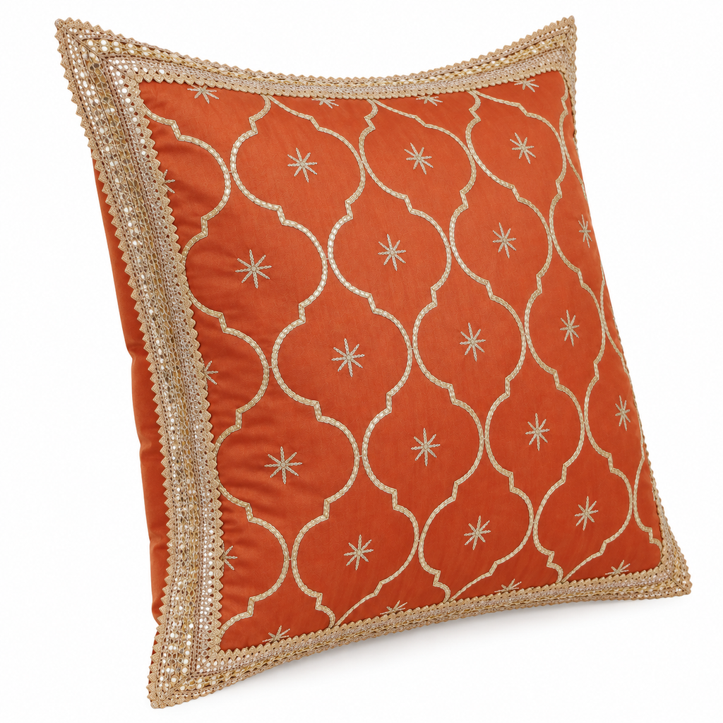 Angled view of rust orange and gold decorative cushion