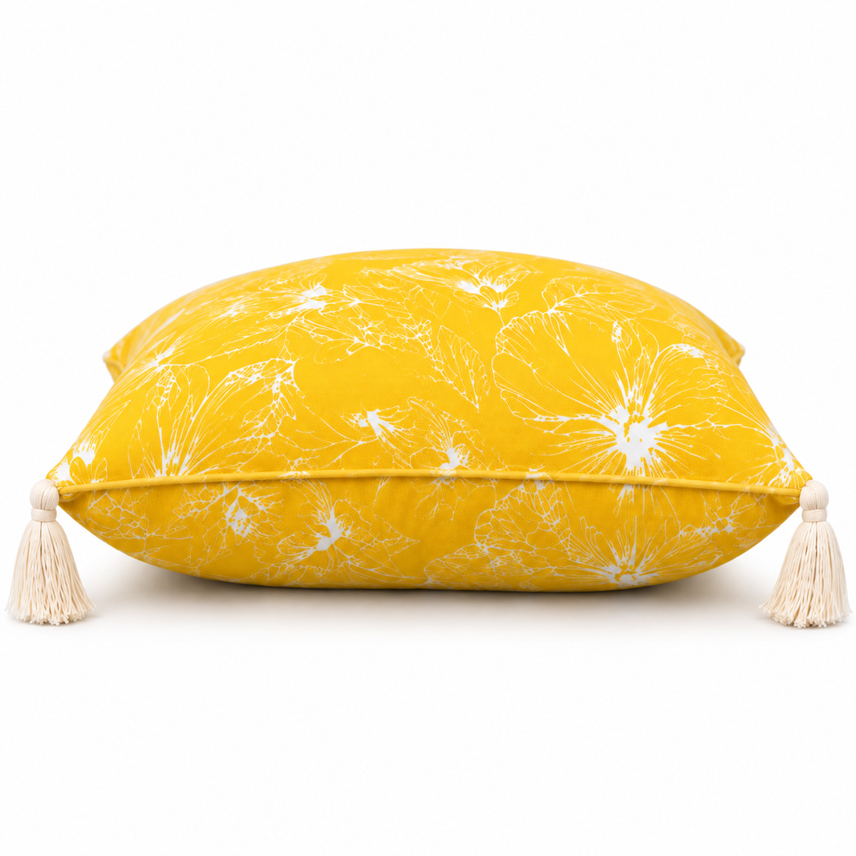 Side view of yellow floral cushion with corner tassels