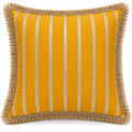 Front view of mustard yellow cushion with vertical gold stripes and fringe